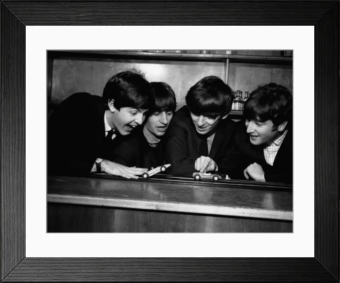 Framed Print : The Beatles in Coventry, amusing themselves with a miniture car race track before their Framed Print : The Beatles in Coventry, amusing themselves with a miniture car race track before their