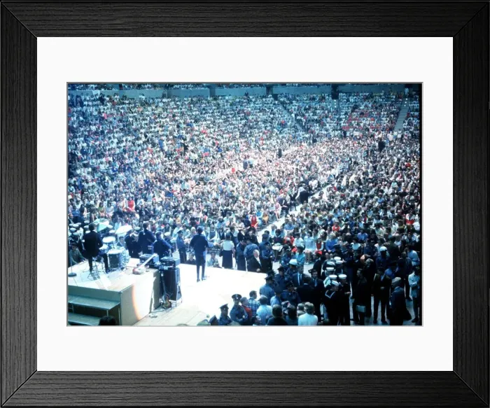 Framed Print : British pop group The Beatles playing to a huge crowd out a packed out music venue during Framed Print : British pop group The Beatles playing to a huge crowd out a packed out music venue during