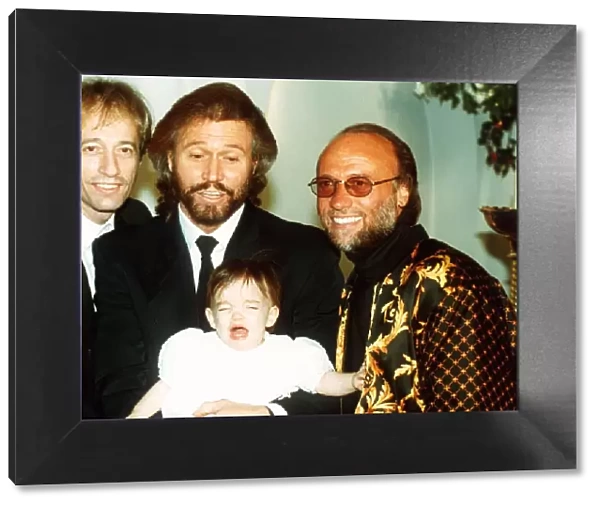 Bee Gees pop group Maurice Gibb Robin Gibb and Barry Gibb with his baby daughter