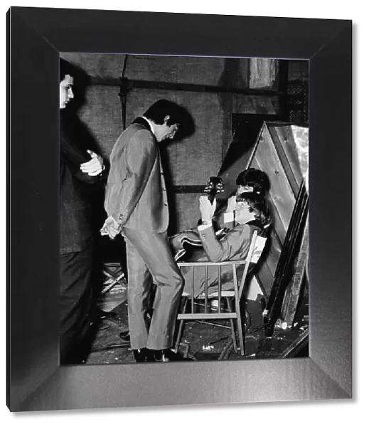 George Harrison, RingoStarr (holding Georges 12-string Rickenbacker guitar