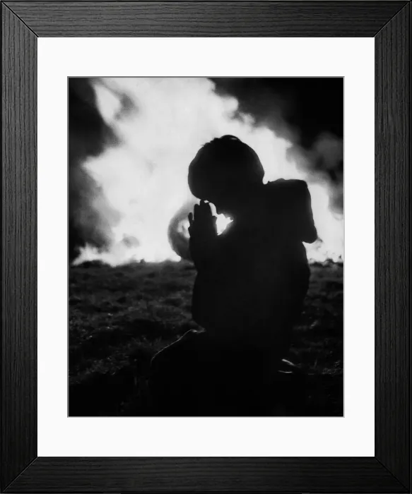 Framed Print : A child prays against the flames of the Bonfire at Stewkley. December 1970 P000327 Framed Print : A child prays against the flames of the Bonfire at Stewkley. December 1970 P000327