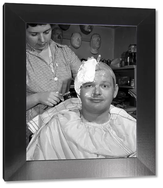 Comedian Benny Hill having a plaster cast of his skull made, so a wig can be made