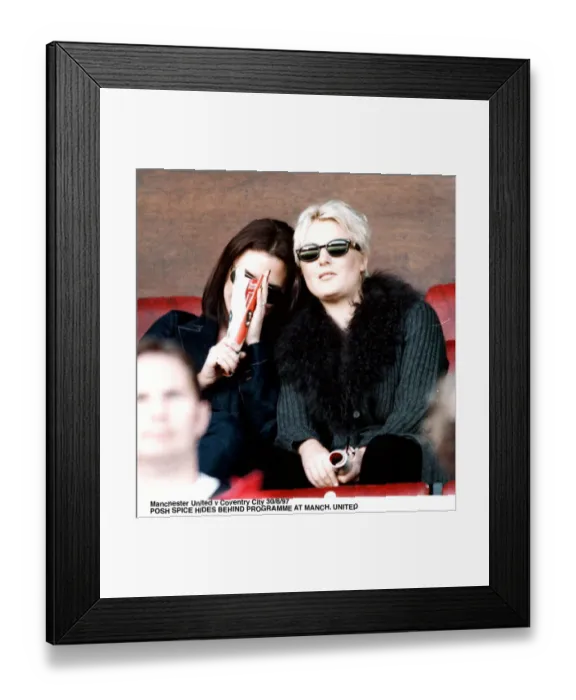 Framed Print : Victoria Adams posh spice of pop group the Spice Girls watching Manchester United v