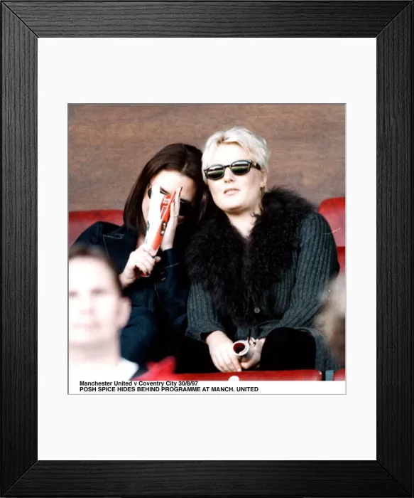Framed Print : Victoria Adams posh spice of pop group the Spice Girls watching Manchester United v