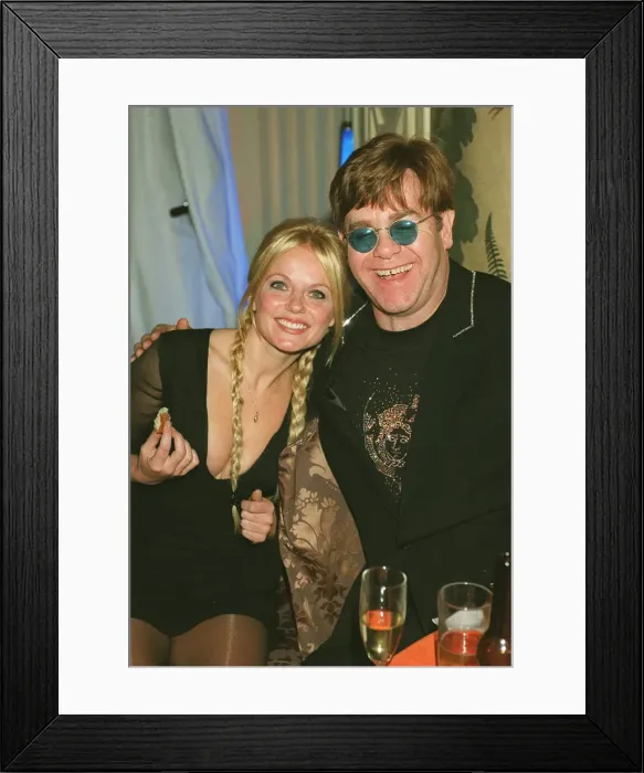 Framed Print : Geri Halliwell and Elton John October 1999 at the premiere of the Lion King