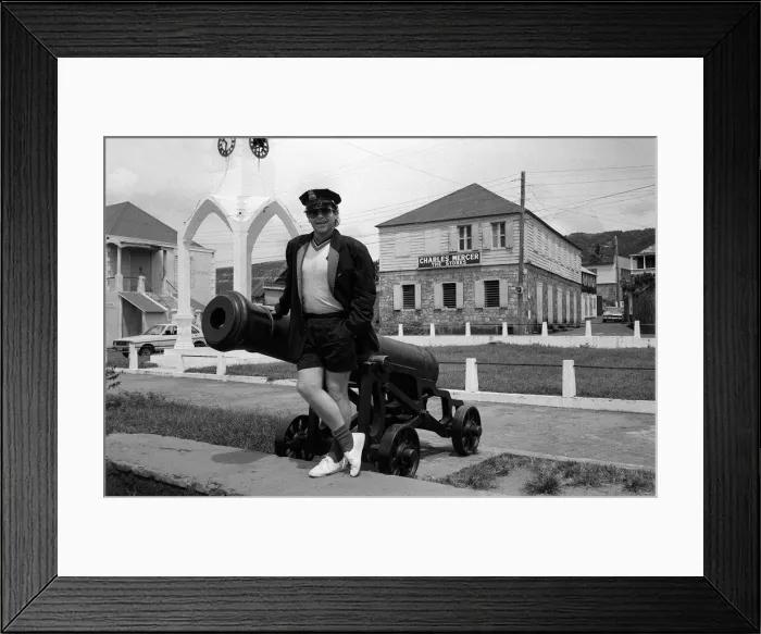 Framed Print : Elton John Singer Songwriter standing beside a cannon on the West Indies Island of