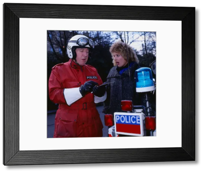 Framed Print : Comedian Rikki Fulton booking Barbara Dickson in the television programme Supercop Framed Print : Comedian Rikki Fulton booking Barbara Dickson in the television programme Supercop