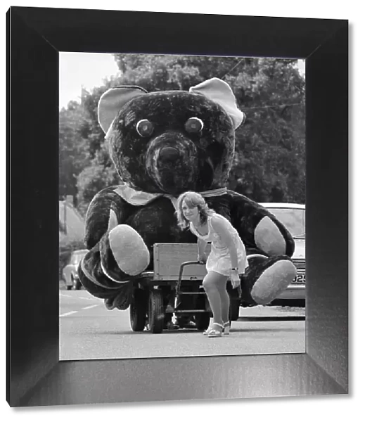 Nineteen year old Elaine Maidment pulls along her giant teddy bear on a trolley through