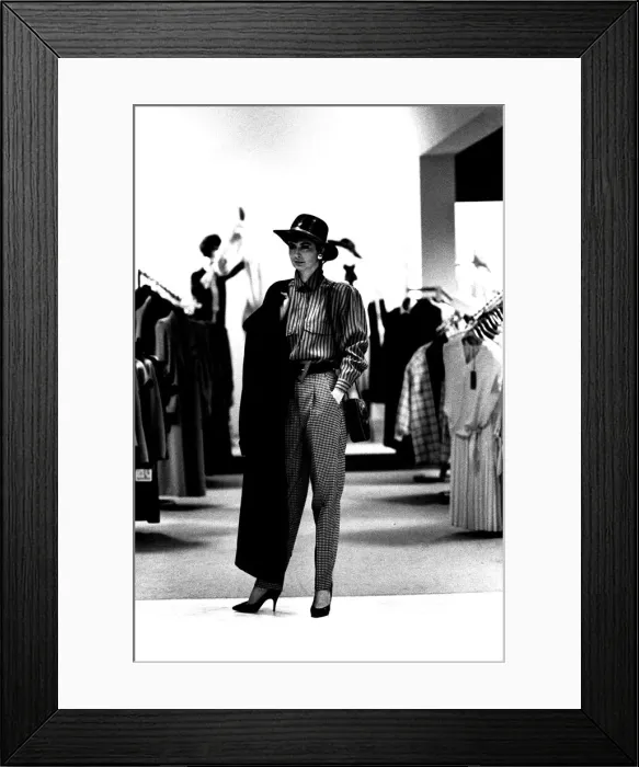 Framed Print : A model wearing some high waisted trousers with a blouse, hat and coat in March 1987 Framed Print : A model wearing some high waisted trousers with a blouse, hat and coat in March 1987