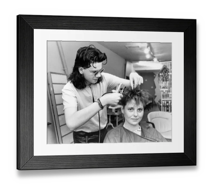 Framed Print : A hair dresser putting hair extensions in model Lisa Houghtons hair in July 1986