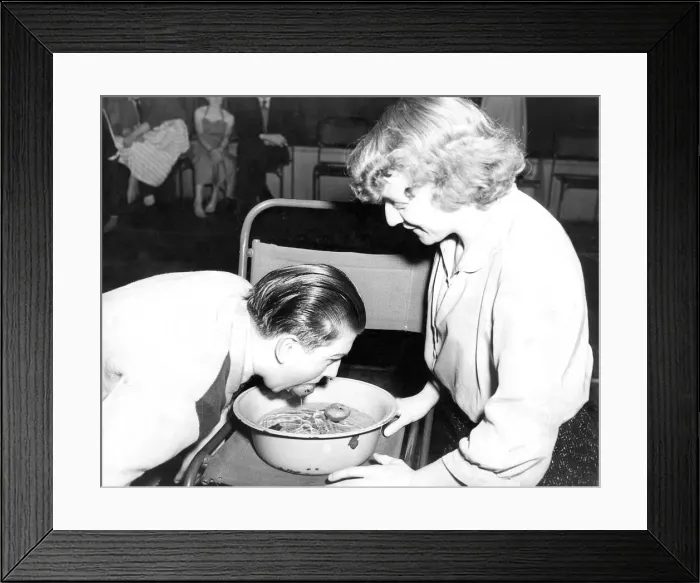 Framed Print : A man bobbing for apples at a halloween part in November 1956 Framed Print : A man bobbing for apples at a halloween part in November 1956