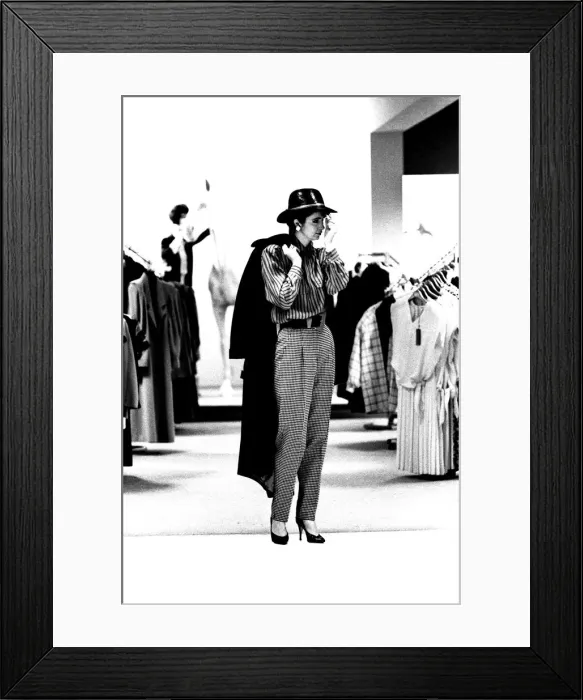 Framed Print : A model wearing some high waisted trousers with a blouse, hat and coat in March 1987 Framed Print : A model wearing some high waisted trousers with a blouse, hat and coat in March 1987