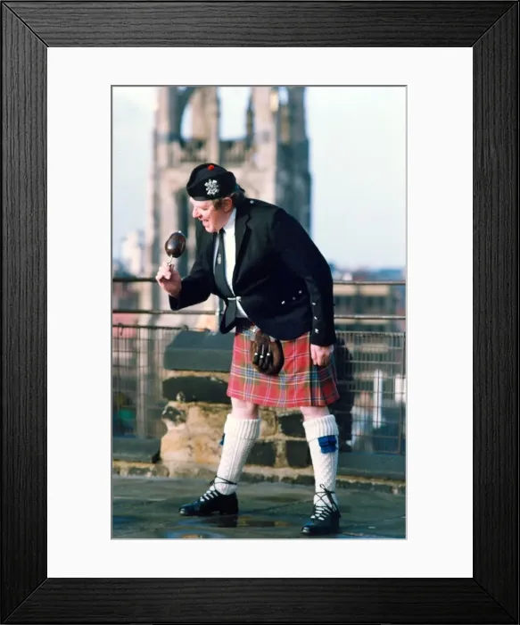 Framed Print : Piper Derek elliott samples a locally grown haggis in January 1994