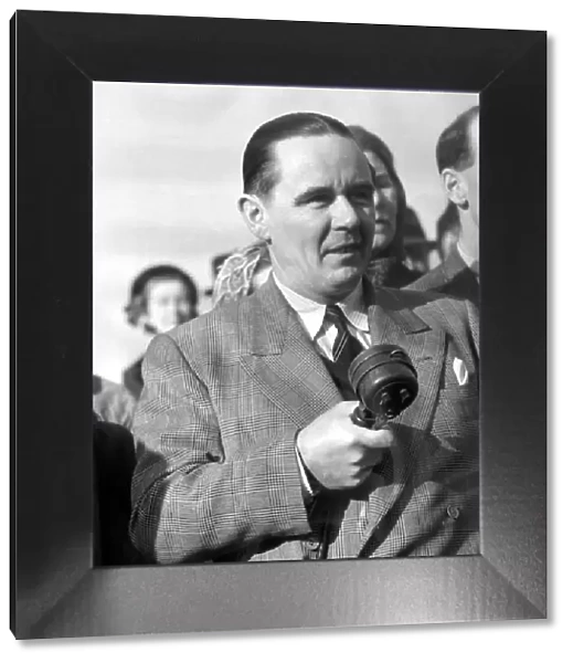 Sunday times golfing correspondant Henry Longhurst with microphone in hand at a meeting