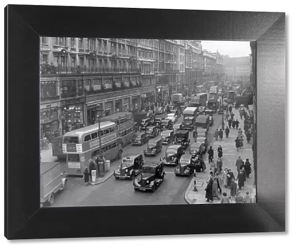 Busy street scene in Oxford Street, London showing heavy traffic. Circa 1950