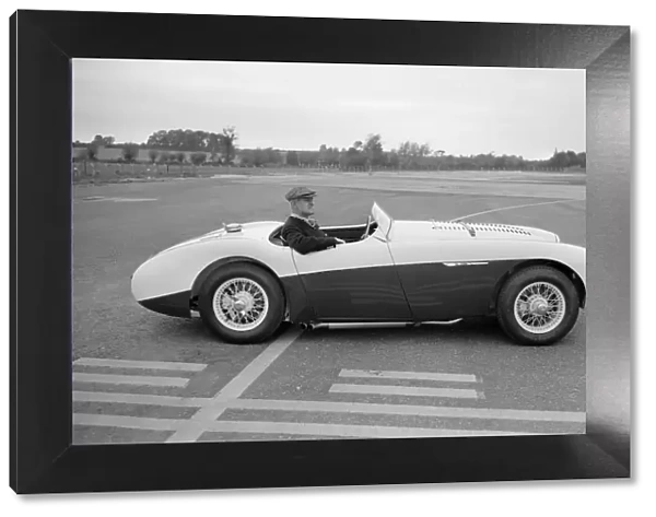 Daily Herald motor racing correspondent Thomas H Wisdom sitting at the wheel of an