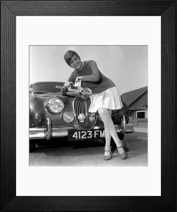 Framed Print : Cilla Black leaning on the grill of a Jaguar Car tearing up L Framed Print : Cilla Black leaning on the grill of a Jaguar Car tearing up L