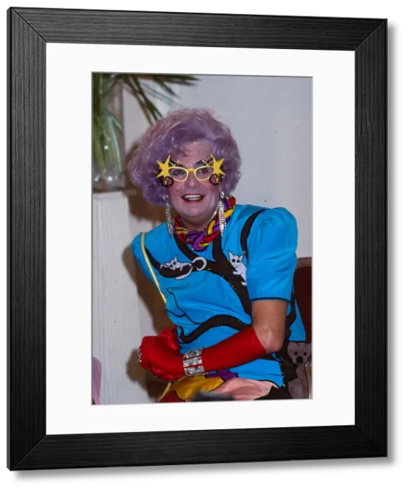Framed Print : Barry Humphries as Dame Edna Everage wearing blue dress red gloves Framed Print : Barry Humphries as Dame Edna Everage wearing blue dress red gloves