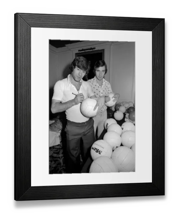 Framed Print : England team at hotel: Alan Hudson left and Malcolm MacDonald sign match footballs Framed Print : England team at hotel: Alan Hudson left and Malcolm MacDonald sign match footballs
