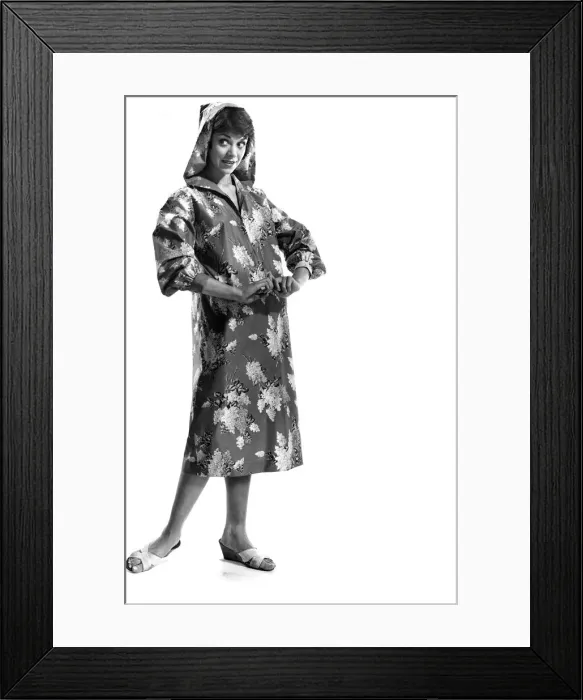 Framed Print : Reveille Fashions. Model wearing floral pattern hooded rain coat. April 1959 P006944 Framed Print : Reveille Fashions. Model wearing floral pattern hooded rain coat. April 1959 P006944