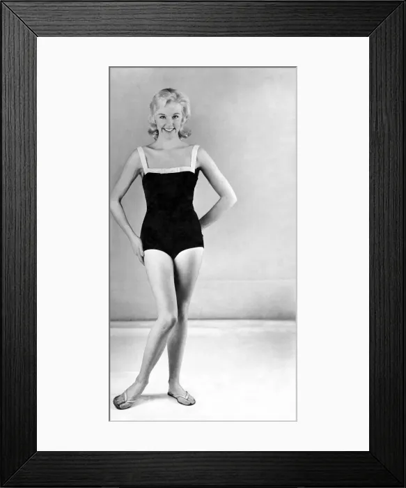 Framed Print : Reveille Fashions. Model wearing a one piece swimming costume and flip flop shoes Framed Print : Reveille Fashions. Model wearing a one piece swimming costume and flip flop shoes