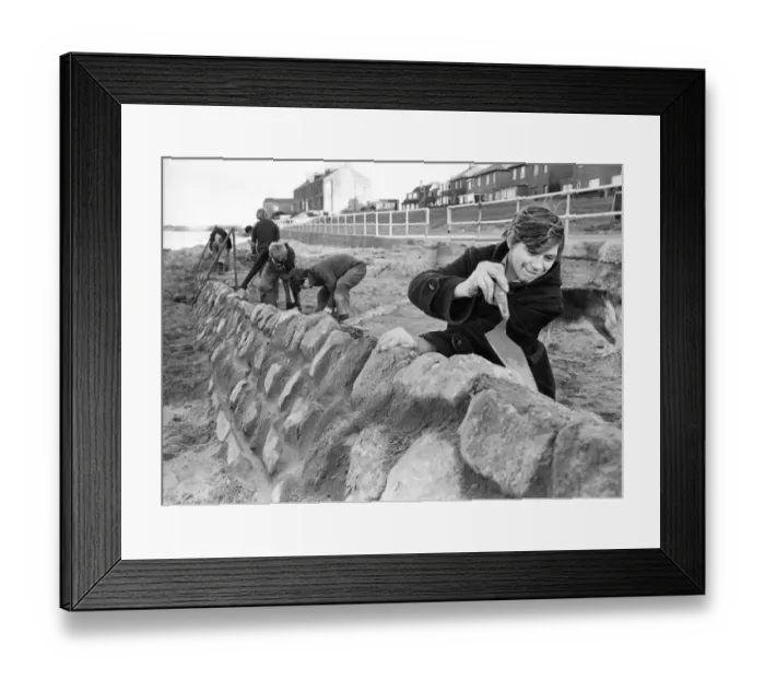 Framed Print : Robert Goward, aged 19, of Hadston, Northumberland, at work on the Amble beach wall in Framed Print : Robert Goward, aged 19, of Hadston, Northumberland, at work on the Amble beach wall in
