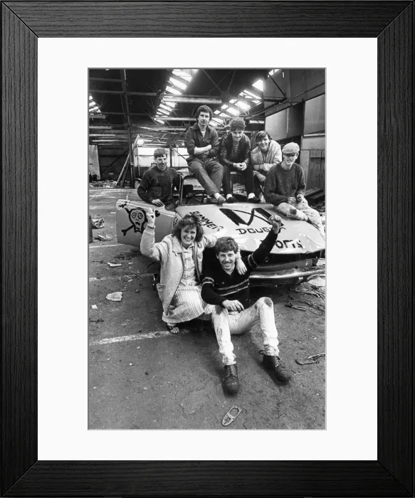 Framed Print : A group teenagers pleased with their efforts after having worked on an old car