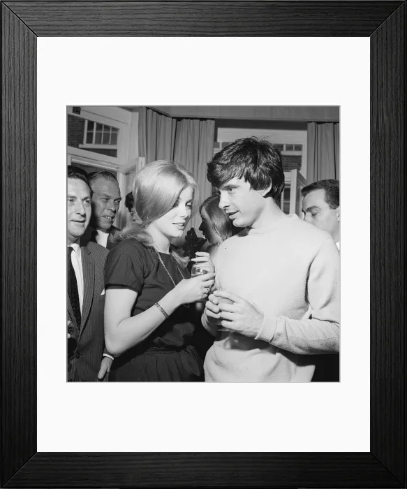 Framed Print : David Bailey and Catherine Deneuve have drinks with guests at a reception after their