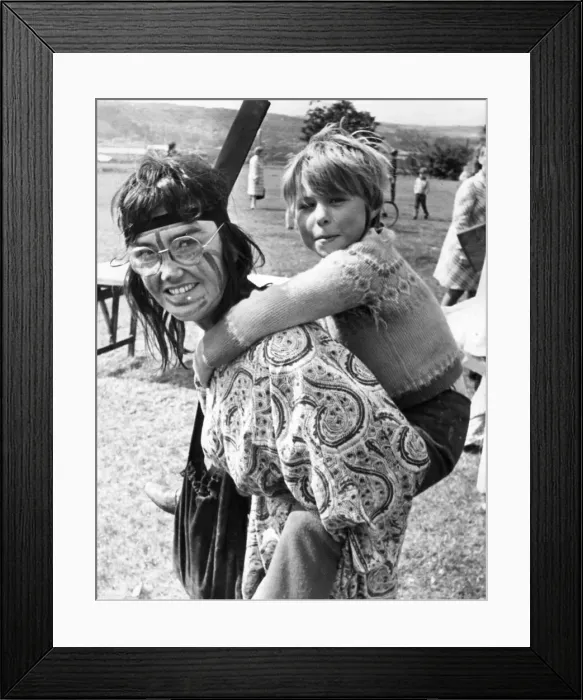 Framed Print : Student colunteer Liz Whybrow gives a piggy-back to Tracy Dishman, 7