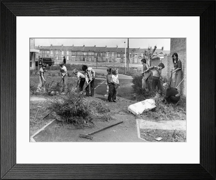 Framed Print : Youngsters take part in a volunteer clean-up of their community in a part of Framed Print : Youngsters take part in a volunteer clean-up of their community in a part of