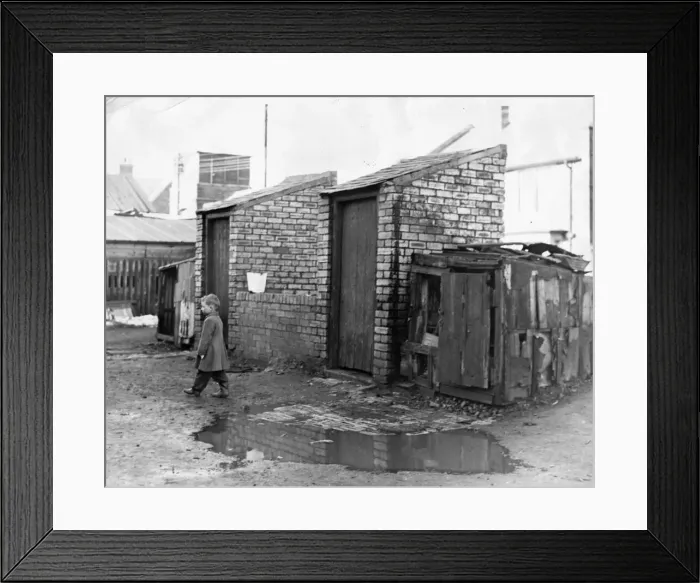 Framed Print : Derelict housing in an area of North East - A young boy walks the flooded walkway to Framed Print : Derelict housing in an area of North East - A young boy walks the flooded walkway to