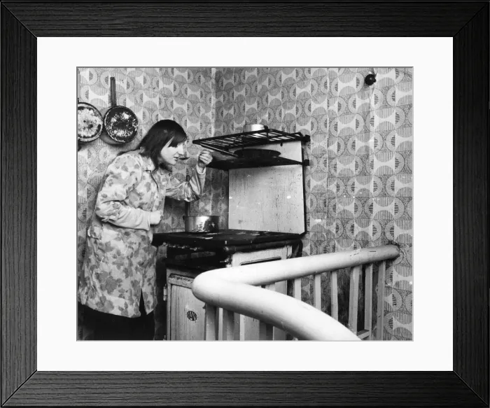 Framed Print : The Interior of slum housing in an area of Newcastle - Jaqcueline tastes her cooking Framed Print : The Interior of slum housing in an area of Newcastle - Jaqcueline tastes her cooking