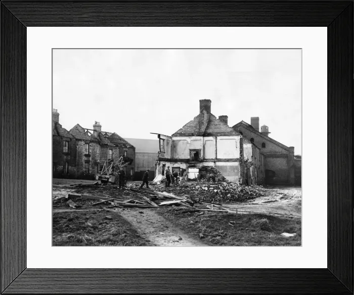 Framed Print : Derelict housing in an area of Stanley - workmen clear the site