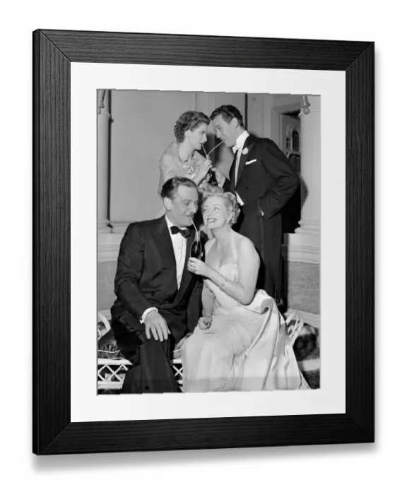 Framed Print : Two couples sharing bottles of coca cola at a party. Circa 1954
