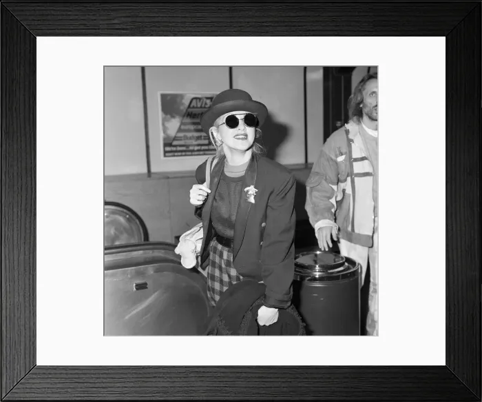 Framed Print : Cyndi Lauper american singer songwriter pictured with manager David Wolff arriving