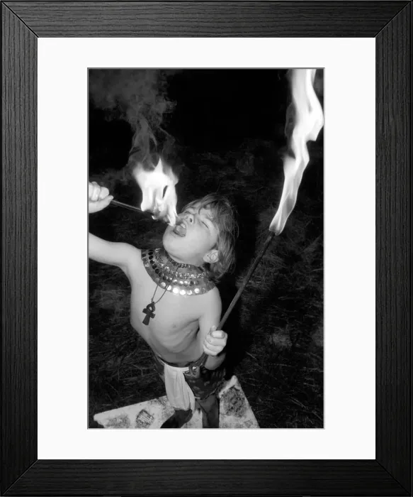 Framed Print : Unusual: Children. Fire Eater. 9 year old Tony Walls. Tony at his Fire Swallowing Act