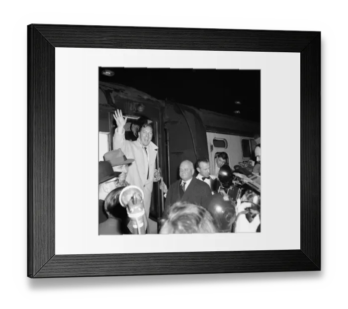Framed Print : American rock and roll singer Bill Haley waves as he arrives in London for his UK tour