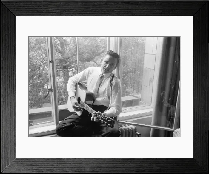 Framed Print : American country singer and musician Johnny Cash poses for photographers at the Savoy