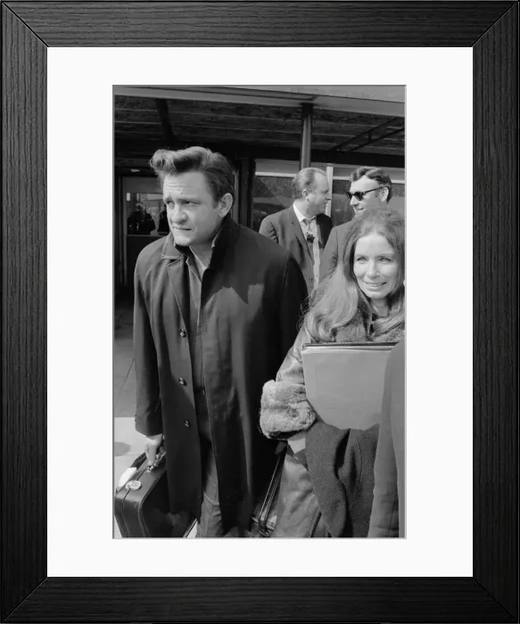 Framed Print : American country singer Johnny Cash with his wife June Carter arriving at Heathrow Framed Print : American country singer Johnny Cash with his wife June Carter arriving at Heathrow
