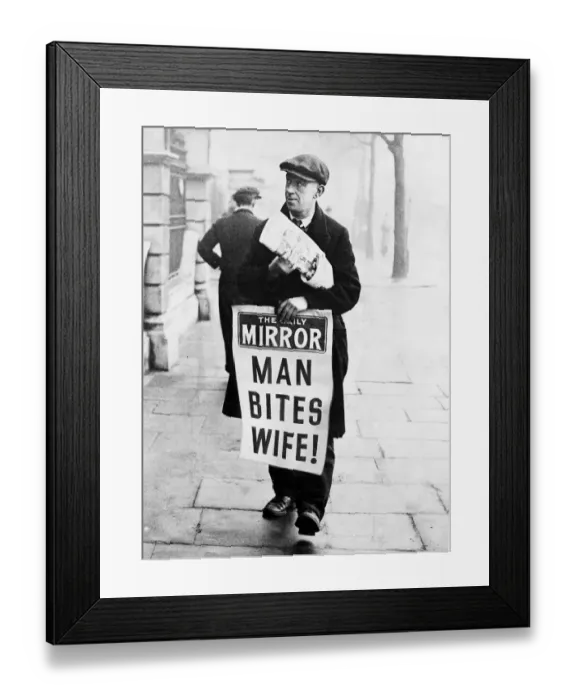 Framed Print : Daily Mirror newspaper vendor carrying advertising hoarding with Man Bites Wife headline Framed Print : Daily Mirror newspaper vendor carrying advertising hoarding with Man Bites Wife headline