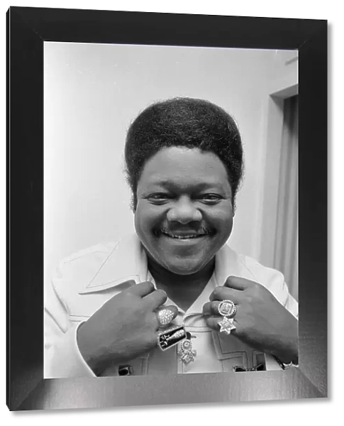 American rock and roll singer and musician Fats Domino shows off his diamond rings in his