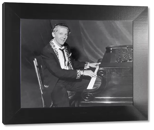 American rock and roll singer and musician Jerry Lee Lewis photgraphed sitting at his