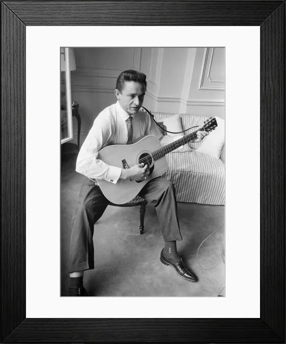 Framed Print : American country singer and musician Johnny Cash poses for photographers at the Savoy