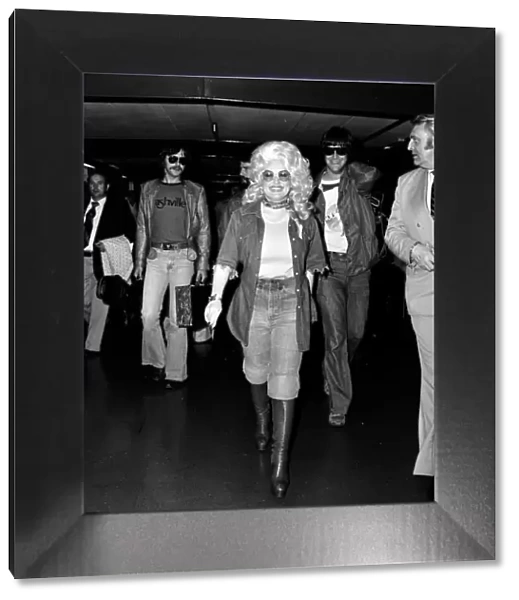 Country & Western singer Dolly Parton arriving at London Heathrow Airport, 16th May 1977