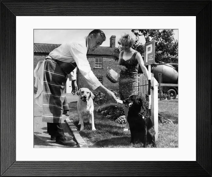Framed Print : The dog post, complete with hooks, is in constant use outside the butcher shop. Mr Framed Print : The dog post, complete with hooks, is in constant use outside the butcher shop. Mr