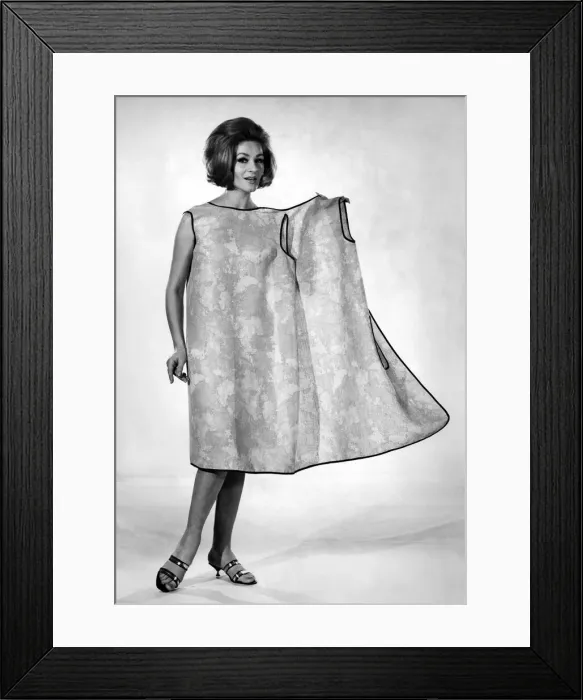 Framed Print : Reveille Fashions: Helen Norman modeling the latest in house coats for the house wife Framed Print : Reveille Fashions: Helen Norman modeling the latest in house coats for the house wife