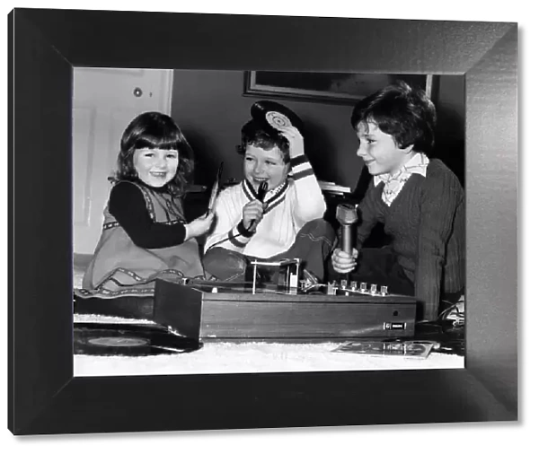 Junior DJ s, children of Disc Jockey Terry Wogan have some fun playing together at