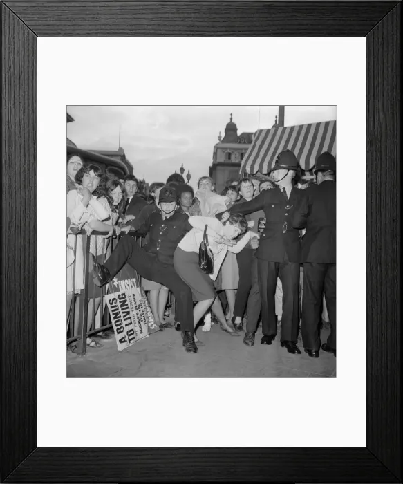 Framed Print : Fans of The Beatles pop group at Piccadilly Circus battle with police as they try to get Framed Print : Fans of The Beatles pop group at Piccadilly Circus battle with police as they try to get