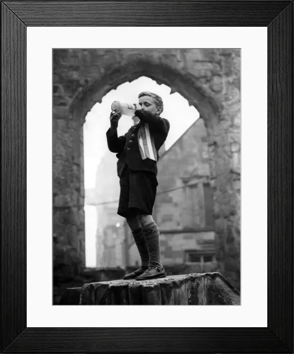 Framed Print : After the VE Day service in the cathedral ruins a youngster bedecked with a rosette Framed Print : After the VE Day service in the cathedral ruins a youngster bedecked with a rosette