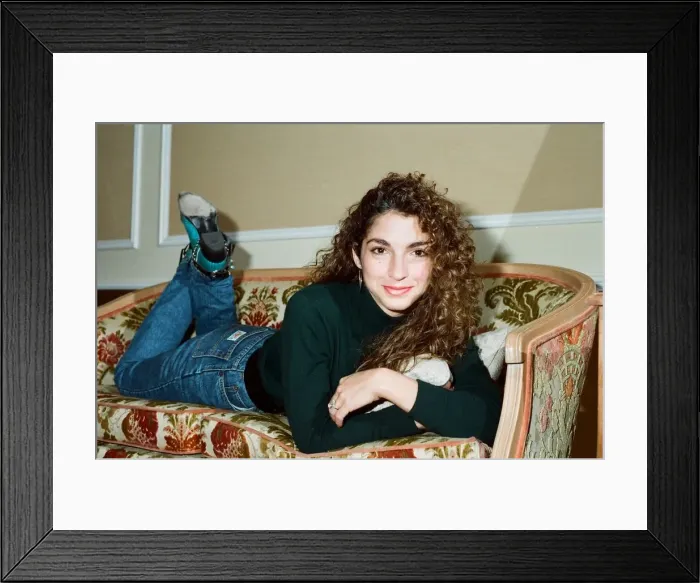 Framed Print : Pop singer Gloria Estefan poses lying down on a sofa in her hotel room on a visit to Framed Print : Pop singer Gloria Estefan poses lying down on a sofa in her hotel room on a visit to